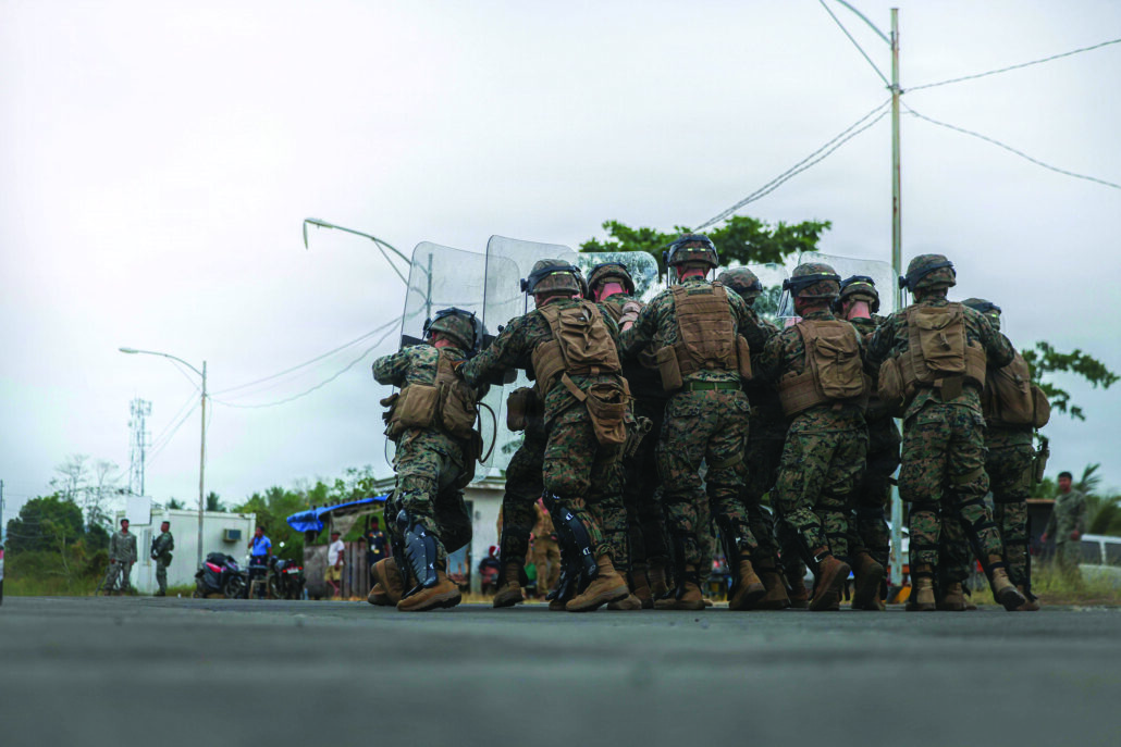 Marine service members conducting riot control training during an exercise to practice real-world missions. 