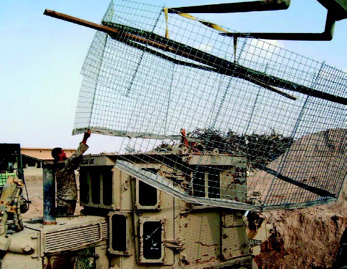 Marines improvise RPG defensive HESCO screens on USMC D9 dozers, Camp Fallujah, October 2004. (Photo by author.)